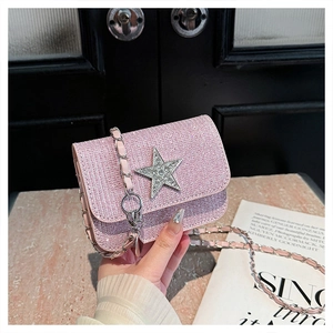 Detail of pink sequin crossbody bag featuring a silver rhinestone star and metal chain
