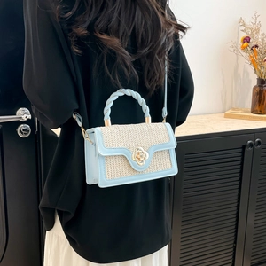 Minimalist light blue and beige woven crossbody bag with metal flower lock and braided handle