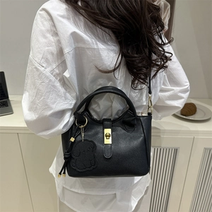 Schicke schwarze Handtasche aus Leder mit Lychee-Maserung und Bären-Anhänger für Damen