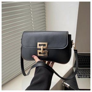 Close-up of black PU leather flap bag with gold geometric buckle and slim shoulder strap