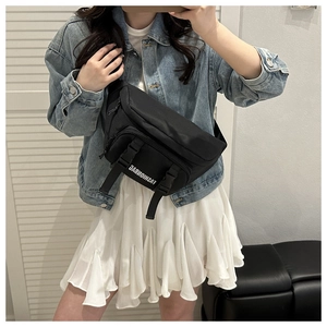 Detail of black street style nylon crossbody bag with buckle and fashion print