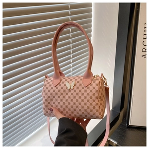 Détail du sac polochon rose avec imprimé logo vintage et fermoir papillon blanc en métal