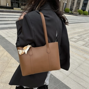 Brown faux leather tote bag for women with orange floral scarf on shoulder strap