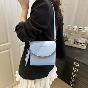 Minimalist light blue square crossbody bag with gold chain and trendy ribbon decor