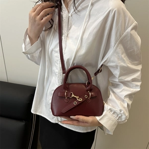 Retro burgundy shell handbag for women with gold hardware and slim shoulder strap