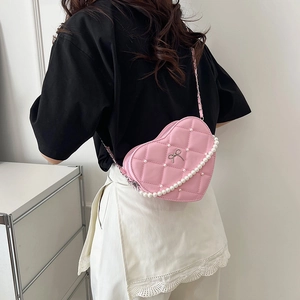 Pink heart-shaped quilted handbag with pearl chain and metallic bow decoration