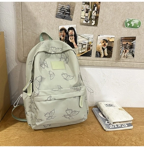 Close-up of mint green butterfly backpack with durable canvas fabric and metal zippers