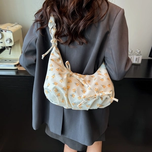 Floral hobo bag for women with yellow flower patterns and bow ribbon details