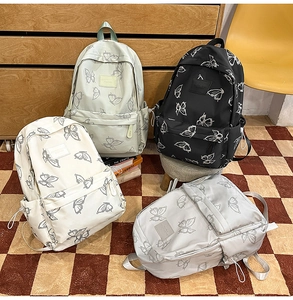 Detail showing butterfly print backpacks in black, white, green, and gray colors