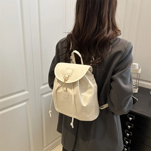 Elegant cream faux leather mini backpack with gold buckle and adjustable straps for travel