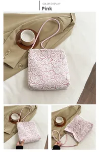 Detailed pink lace shoulder bag featuring white floral embroidery and leather handles