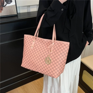 Pink tote bag with brown M-letter print and gold metal charm for daily commuting style