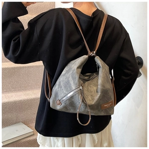Detail of dark grey retro tote bag with leather strap and fashion leather patch