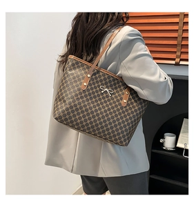 Détail d'un grand sac cabas marron avec motif rétro et boucle métallique décorative