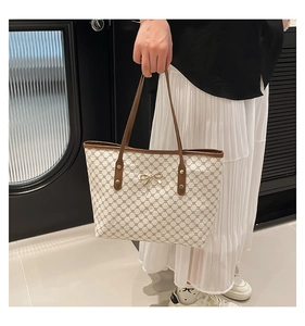 Détail du grand sac cabas avec motif rétro marron et décoration de nœud doré