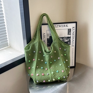 Green handmade crochet tote bag with colorful pearl beads and a woven handle design