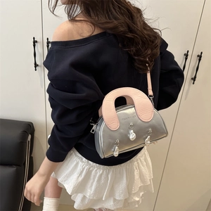 Silver metallic crossbody shell bag with pink handle and pearl charms for women