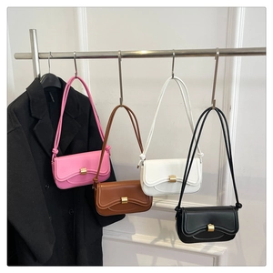 Row of leather baguette bags in pink, brown, white, and black with gold buckles