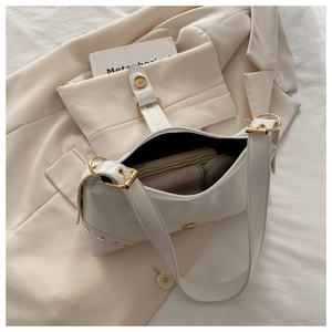 White hobo tote bag with gold buckle and rivets, spacious interior for essentials