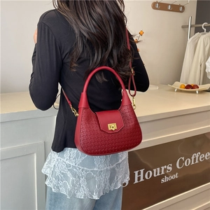 Elegant red woven handbag with gold buckle and crossbody strap for women in 2025 style