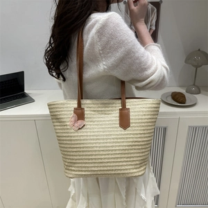 Large straw tote bag with brown leather straps and pink butterfly embroidery for beach