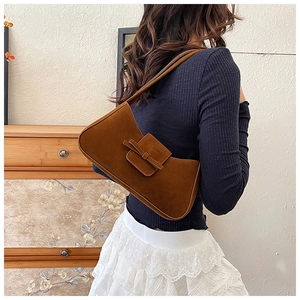 Brown suede baguette bag with bow detail styled with French chic outfit