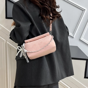 Pink snake-textured crossbody bag with lace pearl bow and silver chain strap