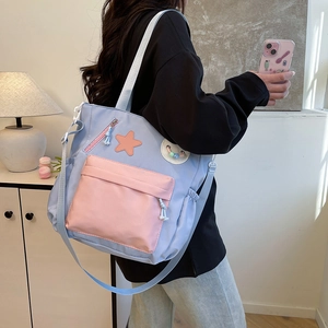Cute contrast canvas tote bag with star patch for students shown in a cozy home setting