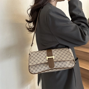 Sac baguette rétro de couleur abricot avec bordure marron et boucle en H dorée