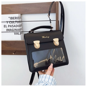 Detail view of black PU leather ita bag showing transparent PVC window and gold hardware