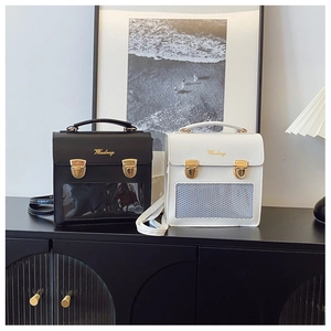 Detail view of stylish PU leather backpacks with gold buckles and clear display windows