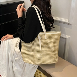 Minimalist straw tote bag with white leather straps and elegant woven texture for women