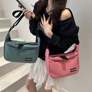 Minimalist canvas messenger bag for commuting shown in teal and pink color options