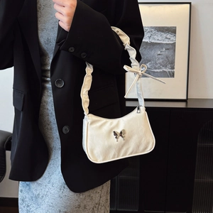 Chic white butterfly underarm bag with ruched shoulder strap for a trendy summer look