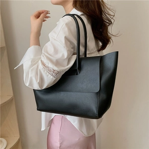 Minimalist black PU leather large capacity tote bag shown on a model for daily commute
