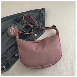 Detail of dusty pink moon bag in corduroy texture with small matching round coin purse