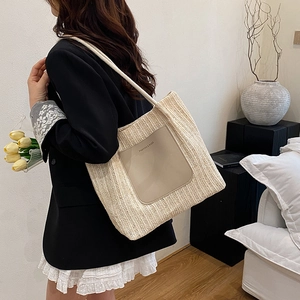 Straw woven tote bag with leather pocket and rope straps for summer fashion commuting