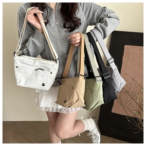 Model showcasing five colors of minimalist nylon crossbody bags with adjustable straps