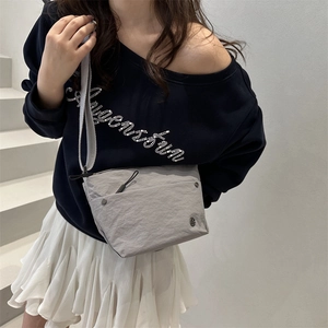 Minimalist grey nylon crossbody bag for women with pleated texture and adjustable strap
