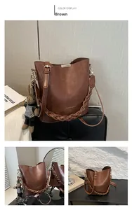Detail of a brown bucket bag featuring a woven handle and a cute knit rabbit pendant charm