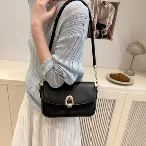 Chic black minimalist square shoulder bag with elegant gold horseshoe clasp for women