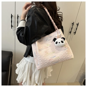 Pink tote bag detail with wave embroidery and cute panda plush pendant on soft shoulder strap