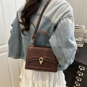 Minimalist square crossbody bag in deep brown leather, worn by a model in casual style