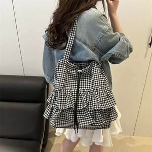Chic black and white gingham tote bag with layered ruffles and drawstring closure