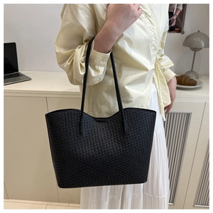 Modern black woven tote bag shown in a lifestyle commuter scene with a leather strap