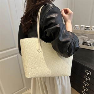 Minimalist beige woven tote bag for women shown with model for daily commute outfit