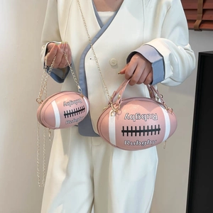 Pink rugby-shaped crossbody bag with gold chain and Rubgby lettering in two sizes