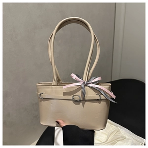Detailed shot of beige PU leather shoulder bag featuring a stylish plaid ribbon bow