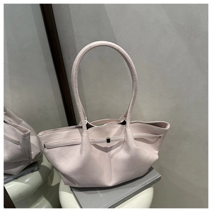 Detail of soft pale pink pleated leather tote with dual straps and metal buckle closure