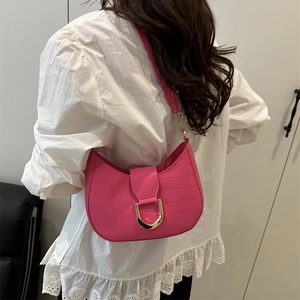 Chic magenta crocodile texture hobo bag with gold buckle worn on shoulder